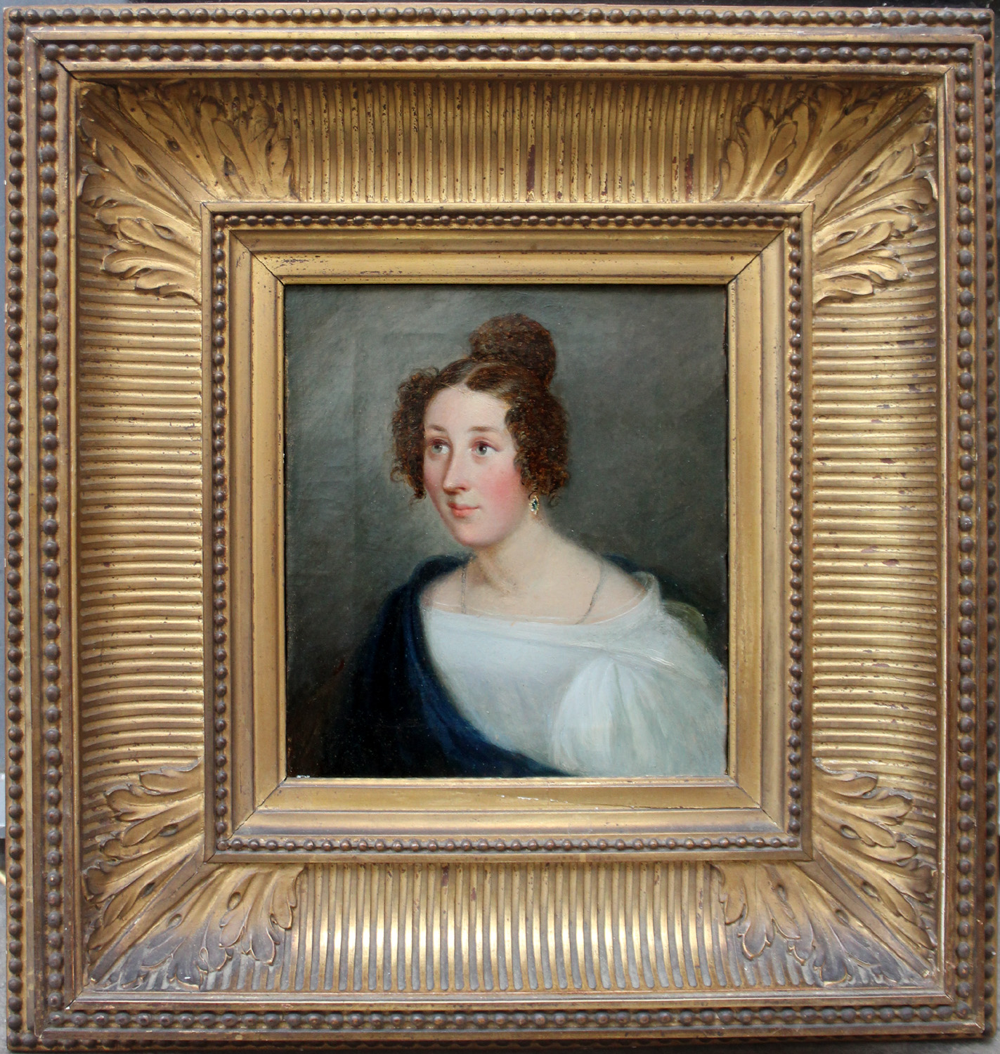 Portrait of young lady in a white dress and a blue scarf